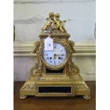 A 19th century French gilt metal mantel clock, the case with scrolls and swags surmounted by putti