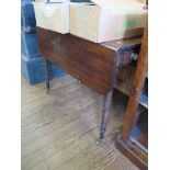 An early 19th century mahogany Pembroke table, the rectangular drop leaves over an ebony strung