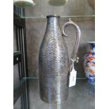 A silver plated bottle holder