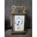 A brass carriage clock, of conventional form, the enamel dial with Roman numerals and alarm dial,