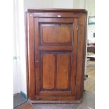 A 19th century pine corner cabinet, the panelled door enclosing four shaped shelves 88cm wide