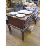 An Edwardian mahogany dressing table, the shaped top over four drawers around a kneehole on acanthus