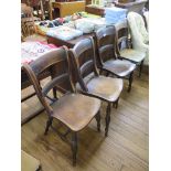 A set of four ash and elm kitchen chairs with rail backs, moulded seats and turned legs joined by