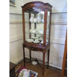 An Edwardian mahogany and boxwood lined display cabinet, with satinwood panels, the arched dentil