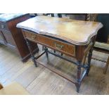 A late 19th century French walnut side table, the shaped top over a frieze drawer on turned tapering