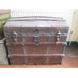 A Saratoga type trunk, the domed lid with wooden slats enclosing two trays, 77cm wide, 57cm deep,