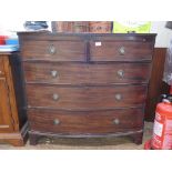 An early 19th century mahogany bowfront chest of drawers, with reeded edge over two short and