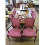 An Edwardian mahogany extending dining table, the rectangular top with canted corners on square