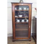 A mahogany bookcase, with adjustable shelves and glazed door on bracket feet, 66.5cm wide, 34cm