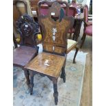 A 19th century Italian marquetry hall chair, with ivory inlay depicting a putto holding a basket