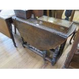 An 18th century oak gateleg table, the oval top over a frieze drawer on turned and block legs and