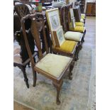 A set of eight Queen Anne style dining chairs, with foliate carved solid splats above drop-in