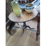 A George III oak snaptop tripod table, the circular top over a birdcage hinge on a baluster stem and