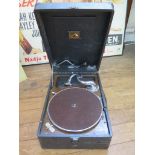 An HMV picnic gramophone player, and four 78rpm records