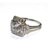 A 18 carat white gold stamped fancy design diamond cluster ring, with old cut centre diamond in a