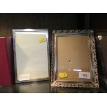 A silver photo frame with engine turned decoration, 19cm x 13cm, together with a silver plated frame