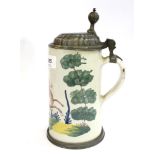 An early 19th century German faience stoneware stein, depicting a stag, the pewter lid engraved with