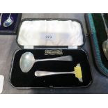 A child's spoon and pusher in original case