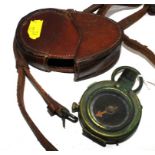 A First World War pocket compass with mother-of-pearl dial, numbered 90633 1917, in a leather case