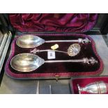 A pair of Victorian silver fruit serving spoons with gilded bowls and cornucopia finials together