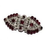 A diamond and ruby double clip circa 1940, breaking down to two clips and a brooch