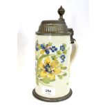 An early 19th century German faience stoneware stein, depicting yellow and blue flowers, the