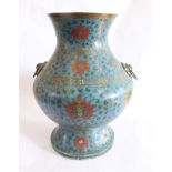 A Chinese cloisonne Hu shaped vase, with bands of floral decoration on a blue ground and with ring