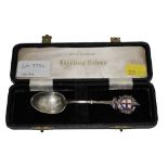 A silver spoon with enamelled London crest finial and engraved design of St. Paul's in the bowl,