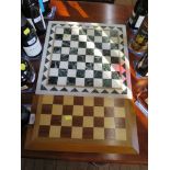 A white and green marble chess board, 41 cm square and a folding chess set