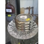 A set of four glass and silver plate coasters together with a Waterford glass dish