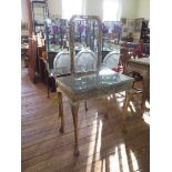 A George I style gilt wood dressing table, the triptych mirror over a foliate scroll decorated top