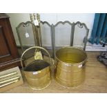 A set of brass fire irons, a fire screen, a brass coal helmet, and a brass log basket