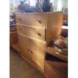 An 1950s oak dressing table and side cabinet by Meredew Furniture, the dressing table with long