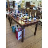 A set of four Chinese style cherry wood dining chairs and a matching rectangular table with turned