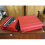 An Olivetti Valentine typewriter in red, with plastic case