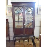 An Edwardian mahogany stain display cabinet, with astragal glazed and panelled doors on cabriole