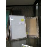 A silver photo frame with engine turned decoration, 19cm x 13cm, together with a silver plated frame