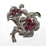 A diamond and ruby two headed flower brooch in fitted Carringtons of 130 Regent Street, London box