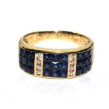 A ladies sapphire and diamond half hoop dress ring, with three panels comprising of three rows of