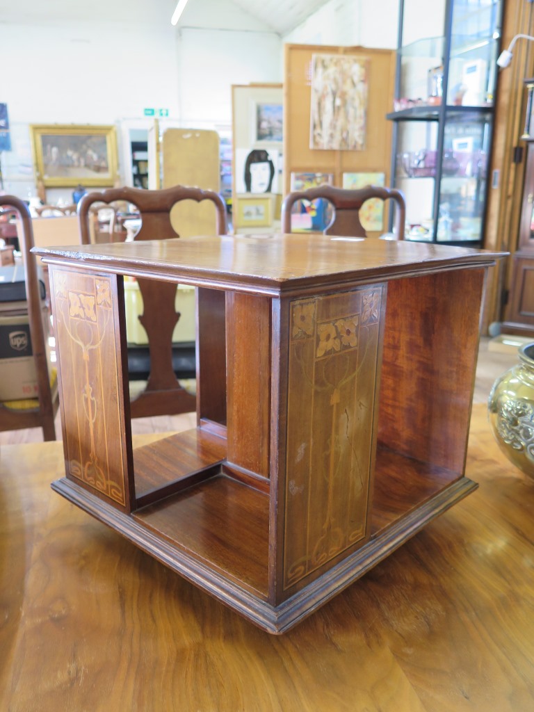 A late Victorian Art Nouveau design inlaid mahogany table top revolving bookcase, 37 cm square, 32.5