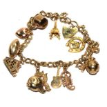 A 9 carat gold charm bracelet with eleven charms