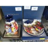 A Moorcroft Pottery Snowmens Greetings design vase, 9 cm high, and a matching dish 12 cm diameter,