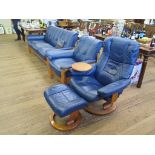 An Ekornes leather four piece lounge suite, in blue, including three seat sofa, armchair, adjustable