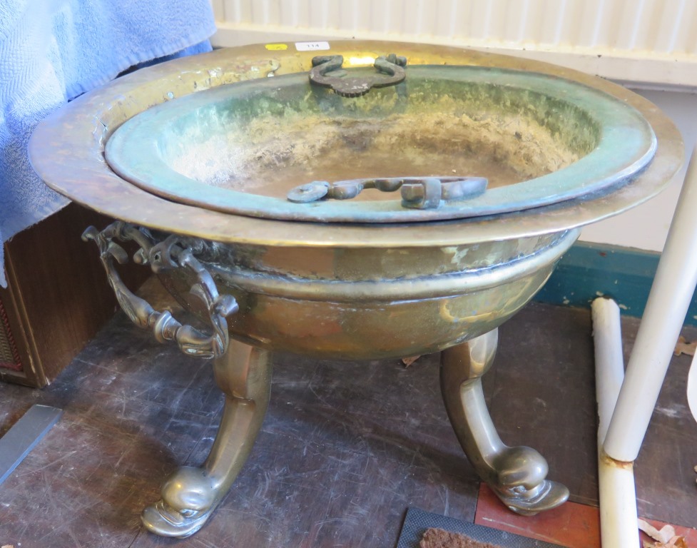 A large brass jardiniere, with twin handles and three scrolling dolphin feet, 51 cm diameter