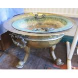 A large brass jardiniere, with twin handles and three scrolling dolphin feet, 51 cm diameter