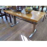 A 1970s adjustable draw leaf table, the rectangular walnut top on a metal frame with adjustable