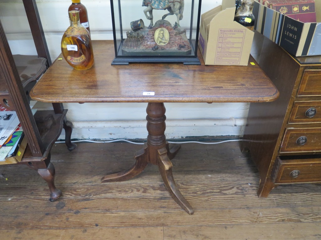 A 19th century mahogany tripod table, the rectangular top on a turned stem, 86 x 60 cm, 70cm high