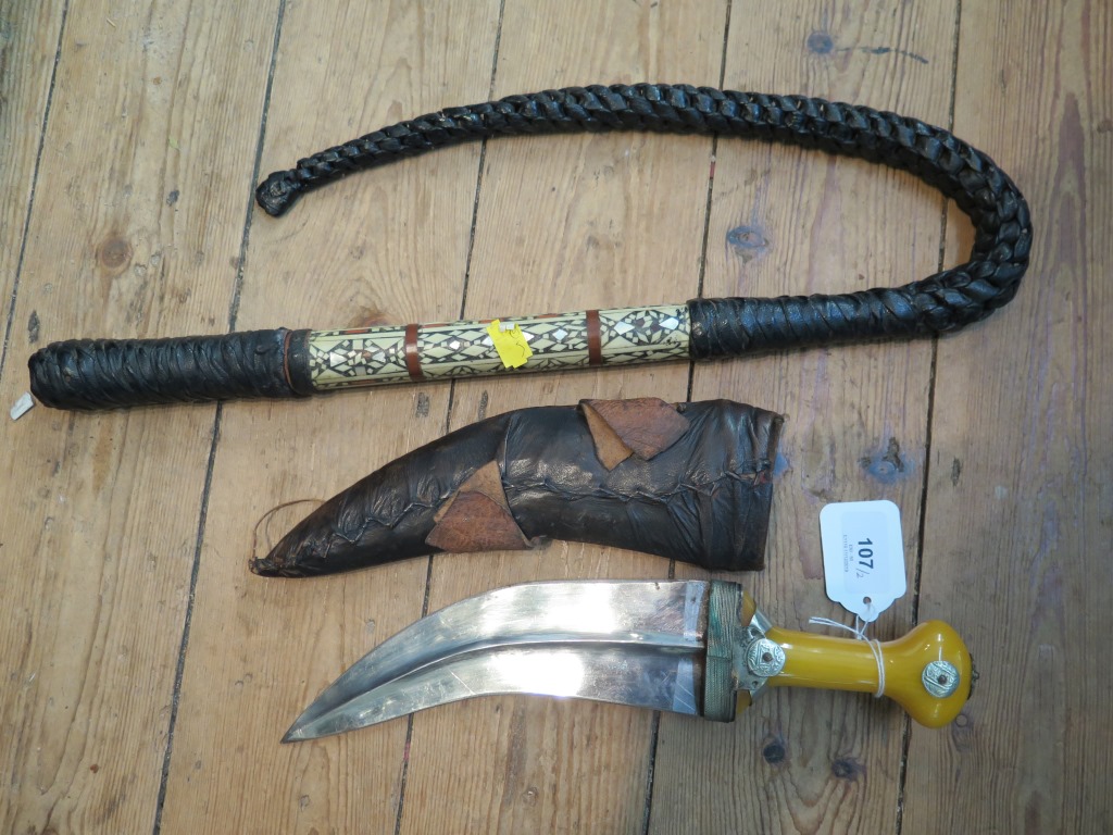 A Middle Eastern mother of pearl inset whip, and a Middle Eastern knife (2)