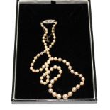 A quality single strand pearl necklace with 18 carat gold three diamond clasp, boxed
