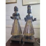 A pair of parcel gilt carved wood Far Eastern figures, each holding their hands out, standing on